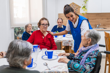 Caring nurse assisting seniors in nursing home