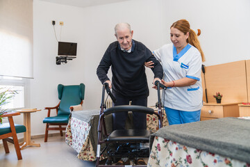 Caring nurse assisting elderly man with walker