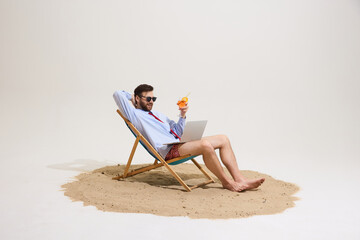 Man lounging on beach chair with cocktail and laptop, wearing sunglasses, formal shirt, tie, swim...