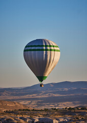 Fototapeta premium Balloons lifted into the air in Cappadocia. Entertainment and tourist attraction. A spectacular sight
