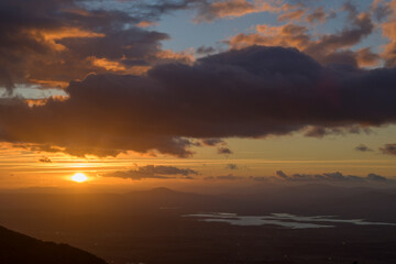 Sun rising at dawn in the mountains with a sky with clouds in the lands of Granadilla in horizontal © MiguelA