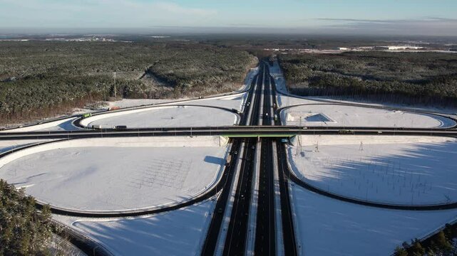 Aerial view of a road junction in a winter landscape. Motorway road junction.