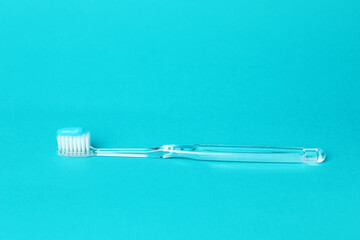 Toothbrush with toothpaste in air on light blue background