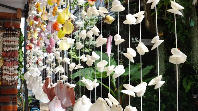 Mollusk shells strung on a string in a souvenir shop, Thailand