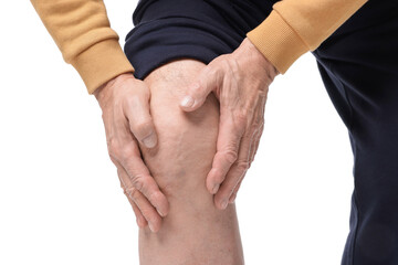 Senior man suffering from knee pain on white background, closeup