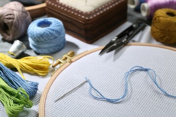 Different sewing supplies for embroidery on table, closeup