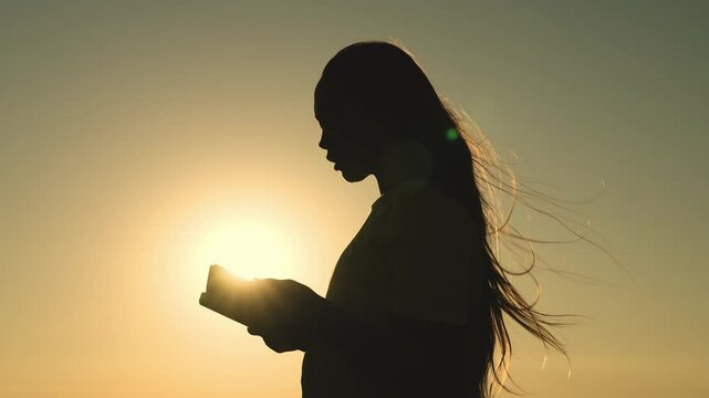girl prays with bible her hands sunset. young girl asks for help. read prayer dawn. human faith dream. ask sky. relaxation concept. happy person lives faith. good book helps find way. pray park sun