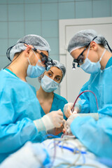 team of surgeons is working in the operating room
