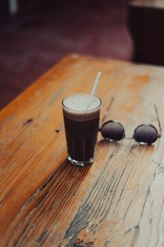 coffee and food placed on wood table 