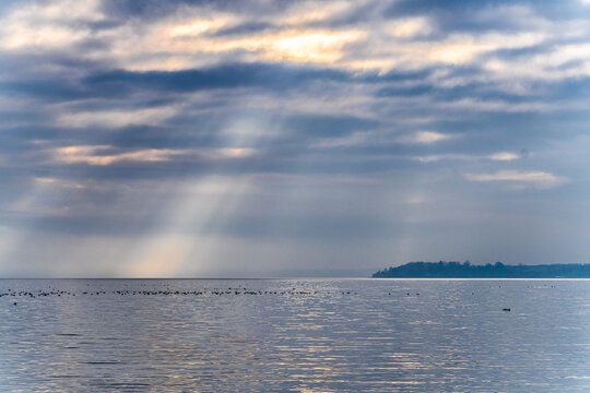 Idyllic Coastal View from Daugaard beach with Green Fields and a Tranquil Sunset Over Water, Denmark