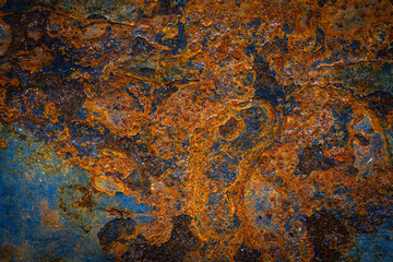 Rusty metal surface with shabby background paint. Blue cracked paint texture on an iron sheet. Fragment of an old metal door, Metal corrosion.