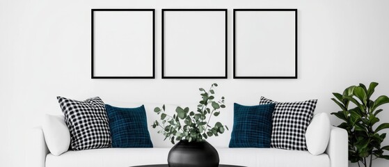 Minimalist living room scene featuring three empty frames on a white wall, a cozy white sofa with patterned cushions, a stylish black vase, and greenery. Home decor. Template.