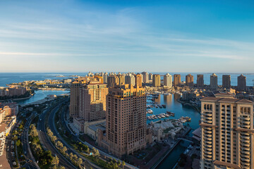 Obraz premium Doha, Qatar - December 20, 2024: Aerial view of Peral Qatar Porto Arabia with Doha Skyline early morning.