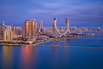 Lusail, Qatar - December 20, 2024: Katara buildings view from Lusail Marina Park. Crescent Tower 