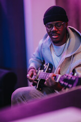 Talented musician plays an electric guitar in a vibrant studio setting, showcasing passion and...