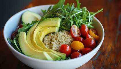 A fresh salad bowl with avocado, quinoa, cherry tomatoes, and arugula, served with a vinaigrette dressing