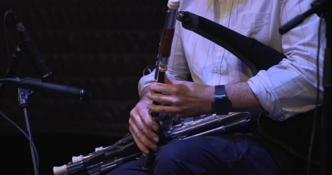 Man playing Uileann Pipes traditional Irish musical instrument