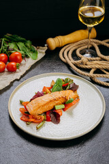 Grilled salmon fillet with fresh vegetables, served on a plate, elegant food presentation