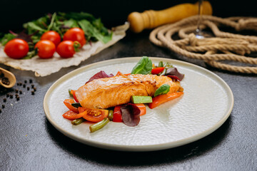 Grilled salmon fillet with fresh vegetables, served on a plate, elegant food presentation