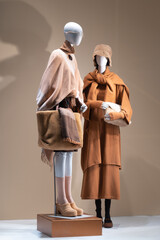 Elegant mannequins showcase fall fashion: warm tones, sophisticated layers, cozy textiles. Perfect for editorial or advertising use
