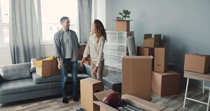 A Couple Excitedly Moving Into Their New Home, Surrounded by Boxes and Possibilities