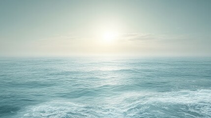 Obraz premium Ocean sunset, calm waves, hazy sky, coastal view, serene landscape