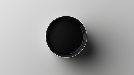 Empty black round container on light gray surface