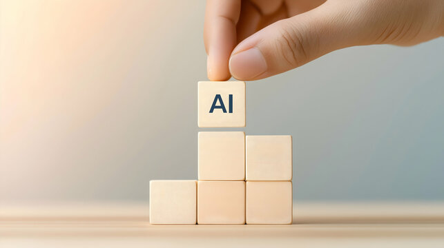 A hand is placing a block labeled "AI" on top of other wooden blocks, symbolizing the building of artificial intelligence.