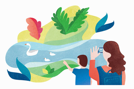 Mother and son looking at swans on pond