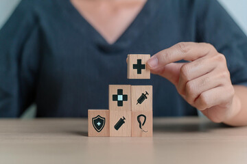 Medical Insurance and healthcare medical. Person holding wooden block with insurance icon