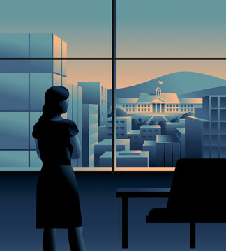 Businesswoman looking out of office window at university lit up in city
