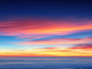 Fototapeta premium Vibrant sunset sky with gradient hues over sea of clouds