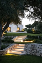 Fototapeta premium Serene evening at a modern villa with illuminated steps leading to a lush garden in a tranquil setting surrounded by trees