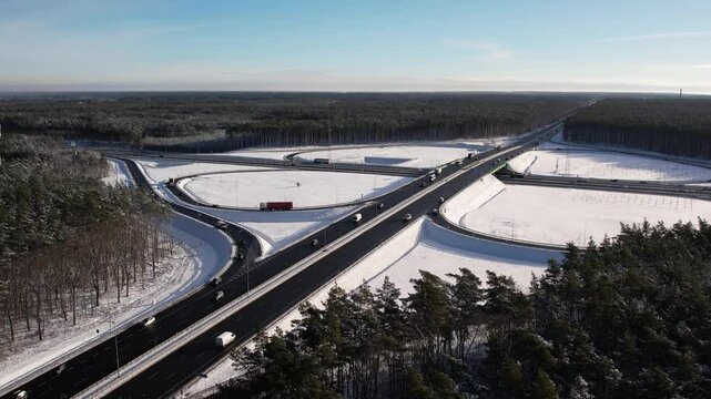 Aerial view of a road junction in a winter landscape. Motorway road junction.