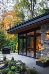This contemporary home harmoniously integrates with its natural surroundings during autumn, featuring elegant design elements and inviting warm lighting that creates a serene atmosphere