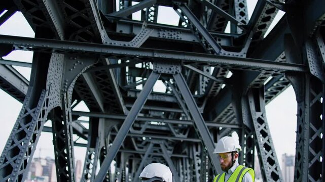 Engineers assess structural integrity while inspecting a bridge in an urban area during the daylight hours