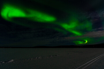 Aurora Borealis - Northern Lights - over frozen lake Akaslompolo in Finnish Lapland.