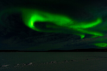 Aurora Borealis - Northern Lights - over frozen lake Akaslompolo in Finnish Lapland.