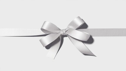 A beautiful white ribbon bow set against a soft gray background, representing elegance and celebration.