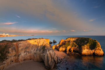 Alvor beach cliffs, Praia de João de Arens at evening sky