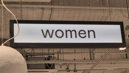 A sign with the inscription women in the department of the store
