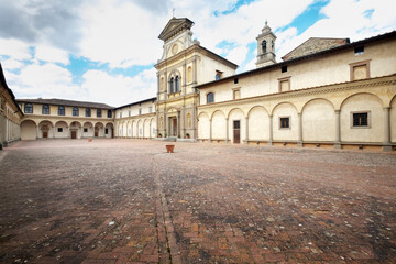 Fototapeta premium Florence, Italy - the Facade of the Church of San Lorenzo at the Florence Charterhouse Framed by Sharp Shadows Against a Blue Sky With Light Clouds