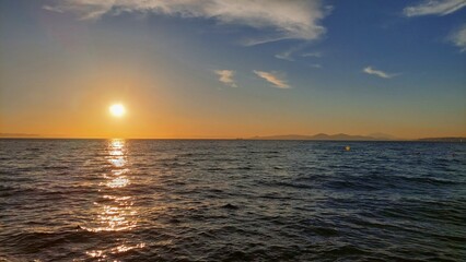 Panoramic sea view with a sunny path at sunset