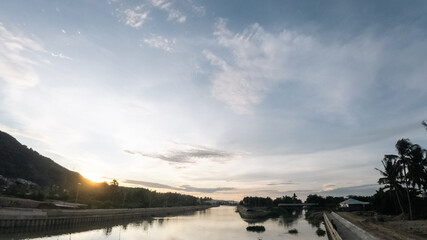 Beautiful sunset over the river in the countryside of Indonesia. Panorama