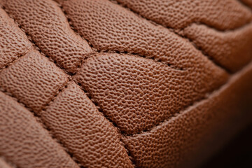 Brown leather texture showing stitching detail in macro view