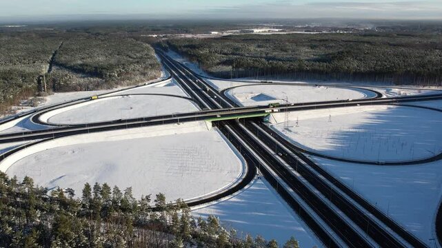 Aerial view of a road junction in a winter landscape. Motorway road junction.
