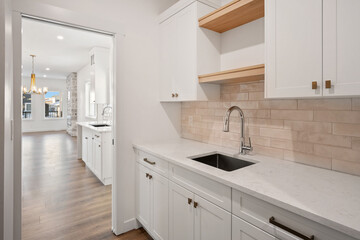 A kitchen with a white sink and a white counter