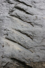 marks and scratches on an old stone wall