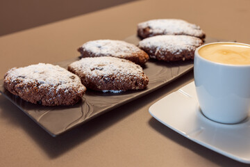 Lombard Pan dei Morti cookies made with dried figs, almonds, and cinnamon, paired with creamy caffe macchiato for a traditional Italian dessert