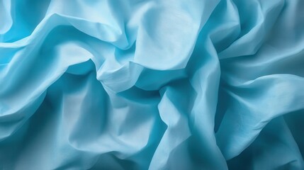 Obraz premium An artistic representation of layered light blue fabric featuring delicate textures that create an illusion of depth and softness, ideal for conveying serenity and elegance.